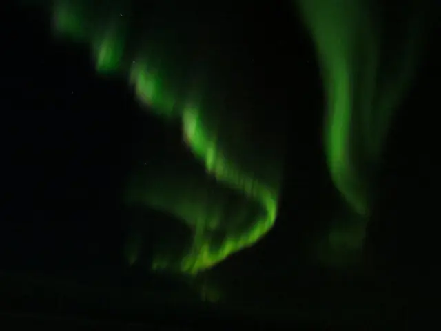 Aurora borealis in the night sky above Greenland