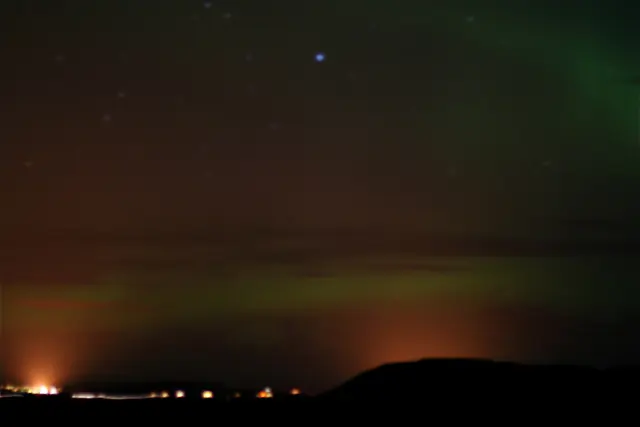 Aurora borealis in the night sky above Greenland