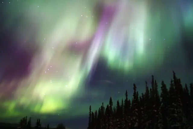Aurora borealis in the night sky above Greenland