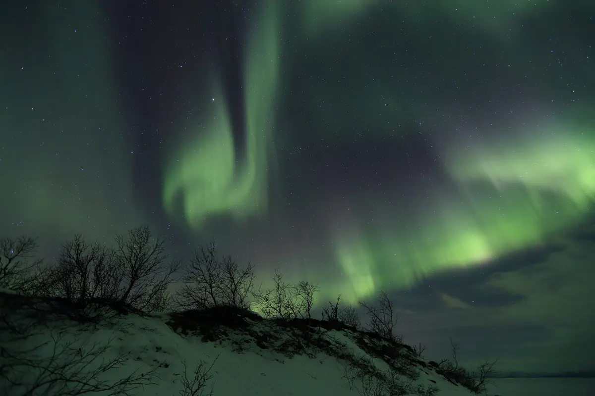 Aurora borealis above Abisko National Park beside Lake Torneträsk in Swedish Lapland